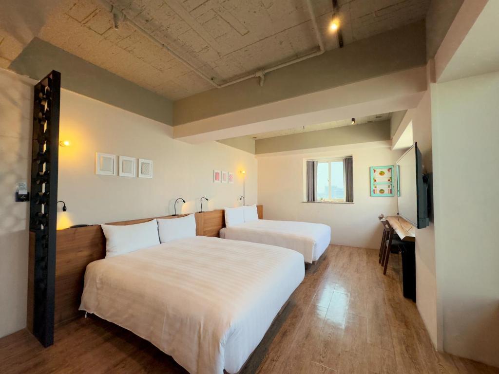 Postel nebo postele na pokoji v ubytování Roaders Hotel Tainan ChengDa