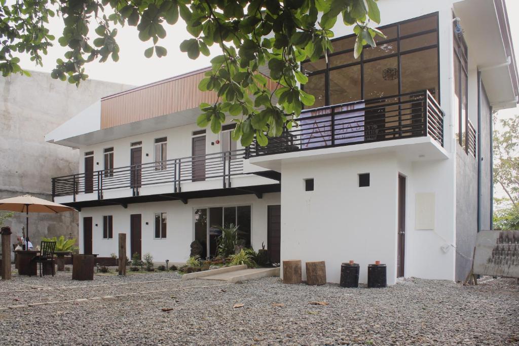 a white building with a balcony on the side at Alicia's Guest House in Butuan