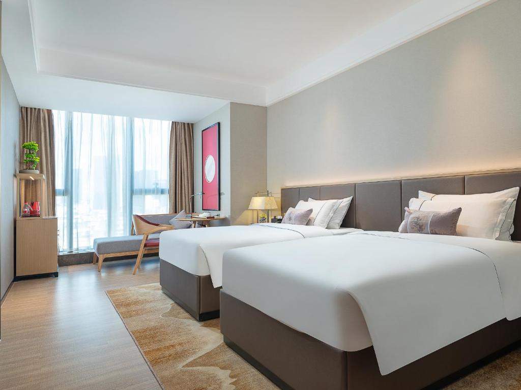Postel nebo postele na pokoji v ubytování Echeng Hotel - Huawei Base Store in Shenzhen