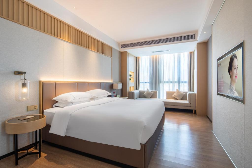 Postel nebo postele na pokoji v ubytování Echeng Hotel - Huawei Base Store in Shenzhen