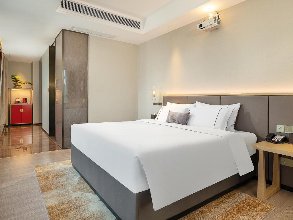 Postel nebo postele na pokoji v ubytování Echeng Hotel - Huawei Base Store in Shenzhen