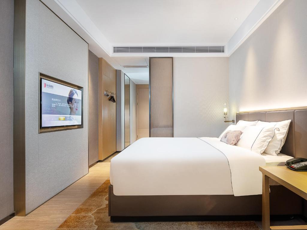 Postel nebo postele na pokoji v ubytování Echeng Hotel - Huawei Base Store in Shenzhen