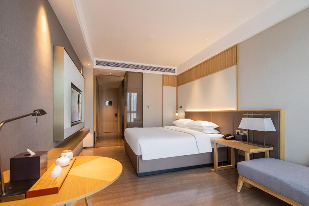 Postel nebo postele na pokoji v ubytování Echeng Hotel - Huawei Base Store in Shenzhen