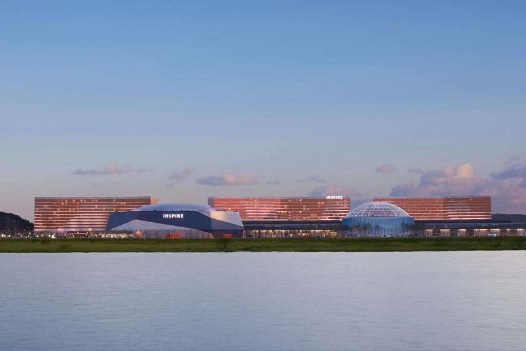a group of buildings next to a body of water at INSPIRE Entertainment Resort in Incheon