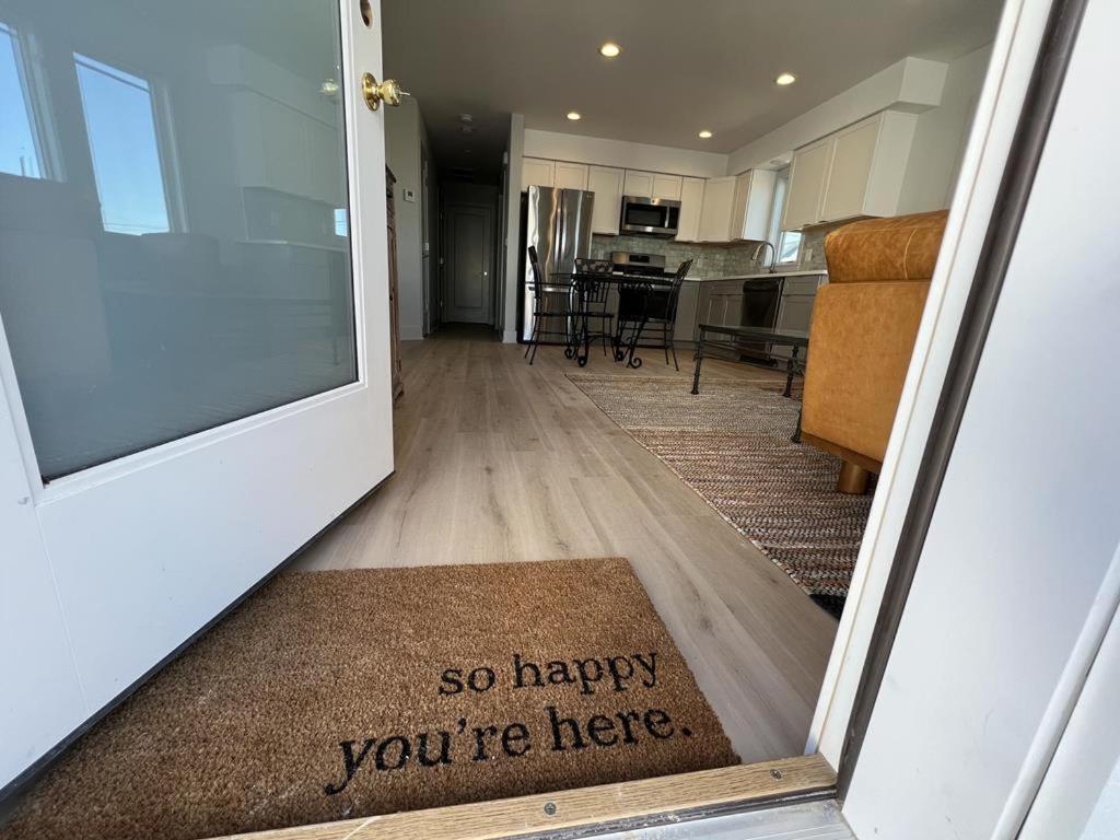 a door with a sign that says so happy youre here at Agresti Mil in Brant Beach