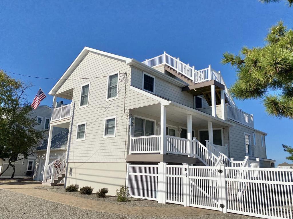 a large white house with a white fence at Family Friendly Vacation Rental On Lbi in Beach Haven