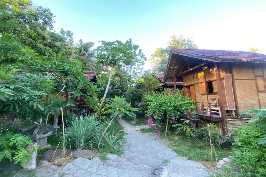 a house with a pathway next to a building at SPOT ON 93511 Rinjana Homestay in Tanjung