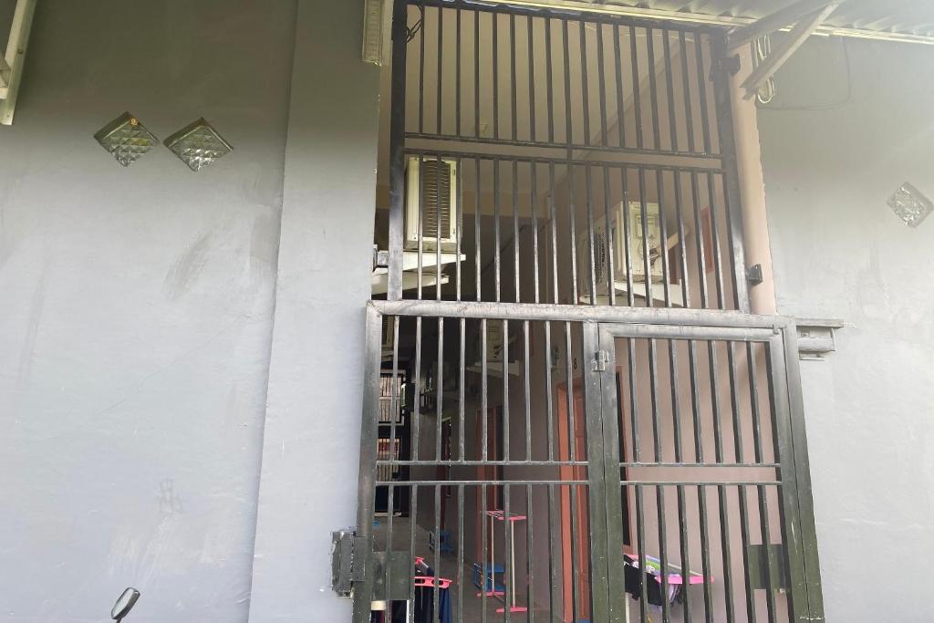 a jail cell with a door in a wall at OYO 93536 Pondok Almirah in Mamuju