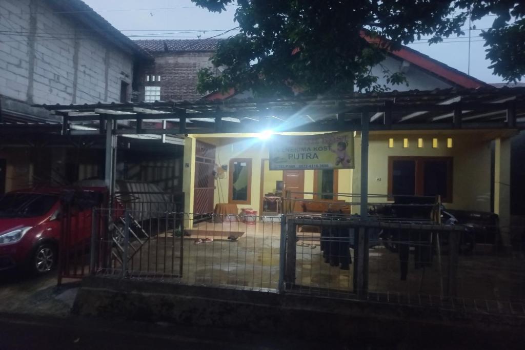 a house with a light on the front of it at SPOT ON 93542 Suripah Kostel Syariah in Banyumas
