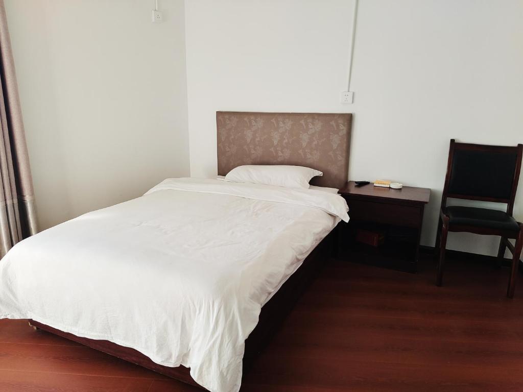 Postel nebo postele na pokoji v ubytování 张家界大庸家民宿天门山索道站店DYJ Residential hostel