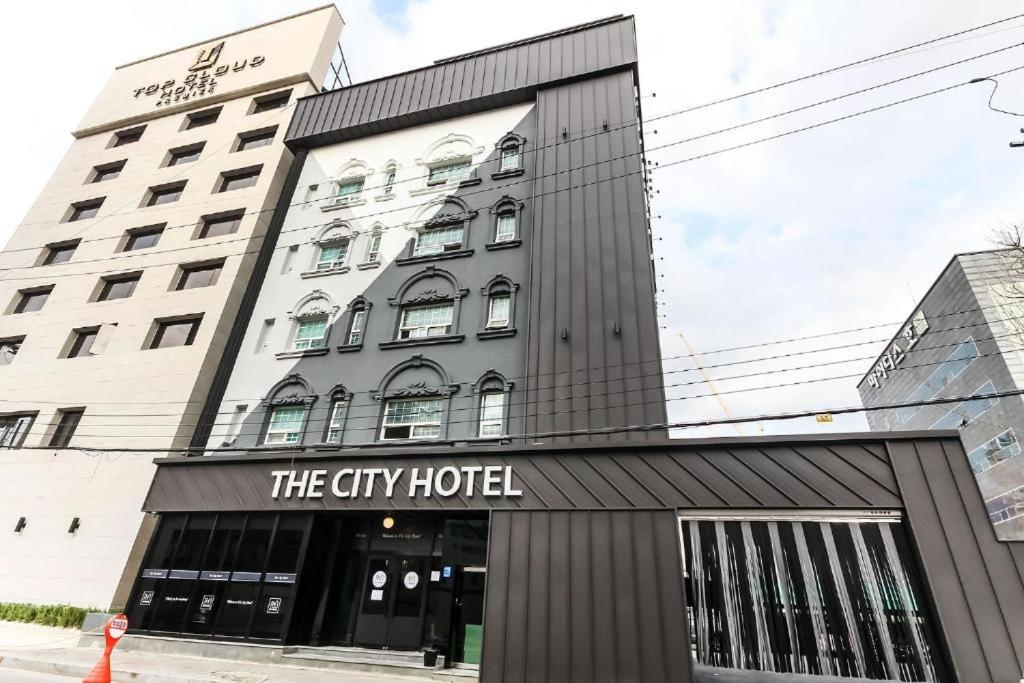 a building with a sign that reads the city hotel at Hotel The City in Gwangju