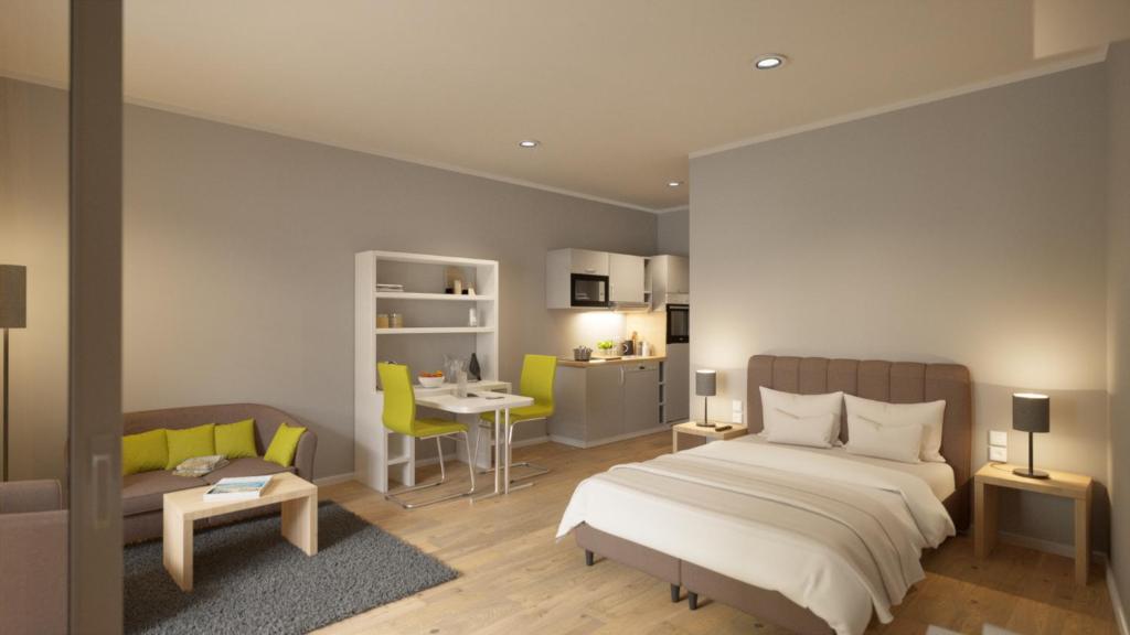 Adapt Apartments Wetzlar في فيتسلار: غرفة نوم بسرير واريكة وطاولة