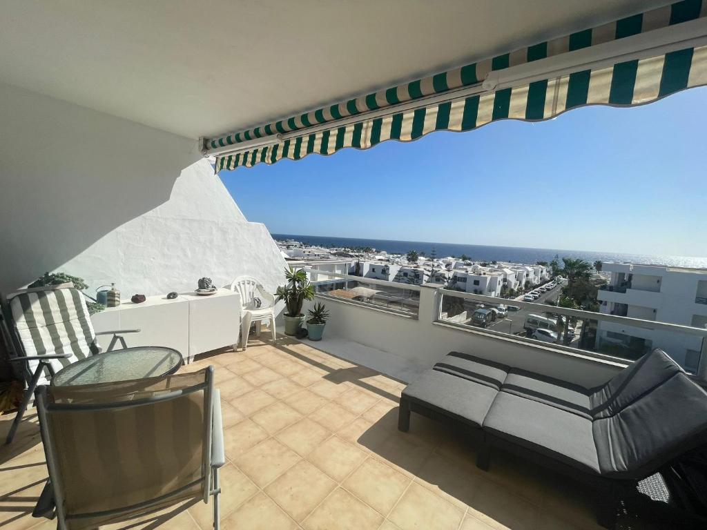 a balcony with a view of a city at Ocean Kiss Apartment in Puerto del Carmen