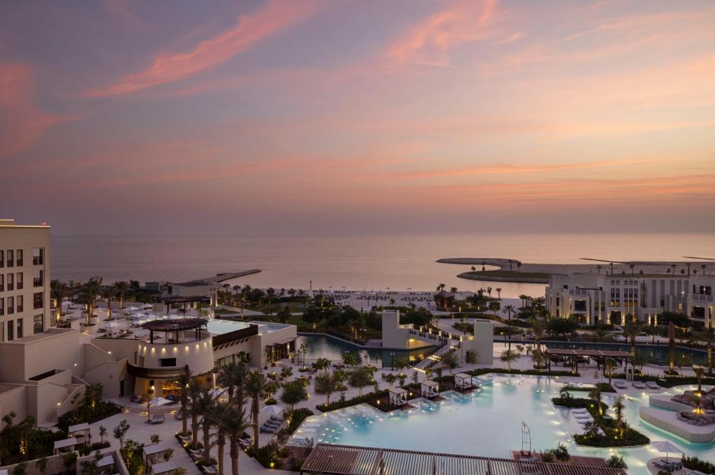 an aerial view of a resort with a pool at Jumeirah Gulf of Bahrain Resort and Spa in Manama