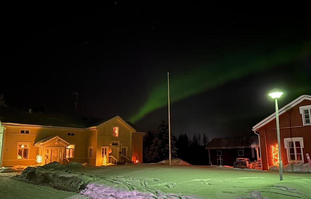 Un'aurora risplende nel cielo sopra una casa di Liepeen pappila a Pudasjärvi