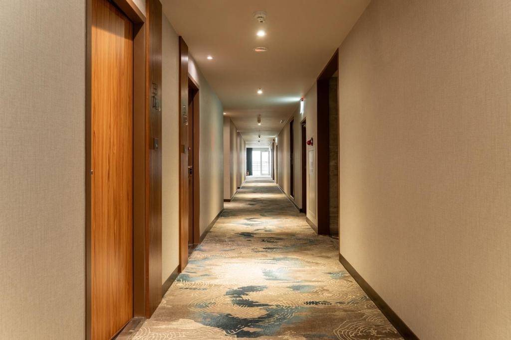 a hallway with a long corridor with a tile floor at Home Hotel in Taipei