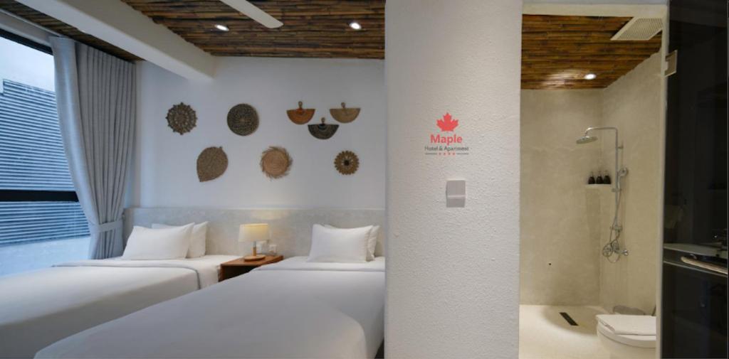 Postel nebo postele na pokoji v ubytování Maple Hotel & Apartment