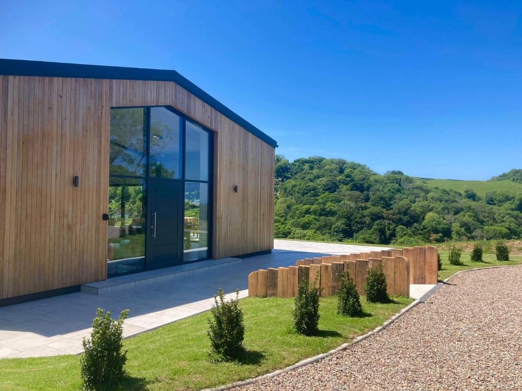 a modern house with glass doors and a fence at 4 Bed in Berrynarbor 65786 in Berrynarbor