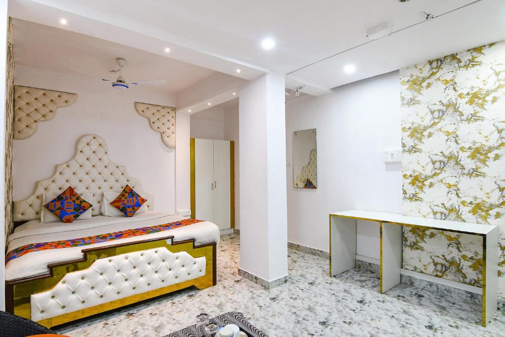 a bedroom with a bed and a desk at FabHotel Prime Rockstar in Ballygunge