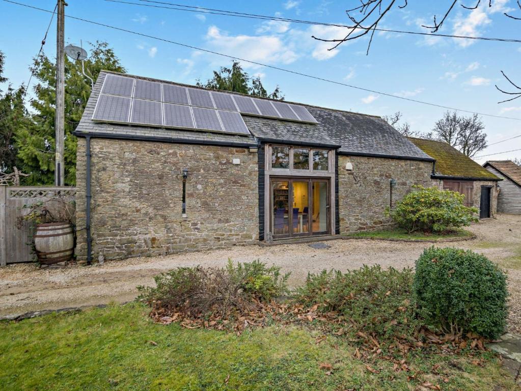 an old stone house with solar panels on it at 2 Bed in Coleford 78181 in Symonds Yat