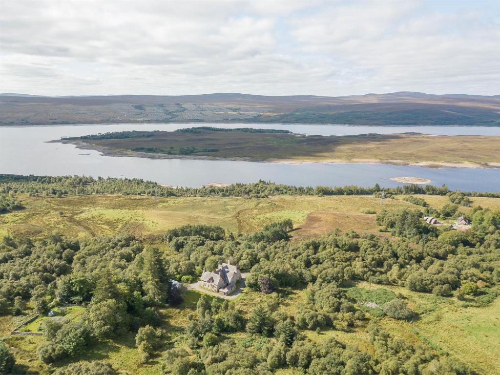 an aerial view of a lake and a castle at 6 bed in Lairg CA301 in Lairg