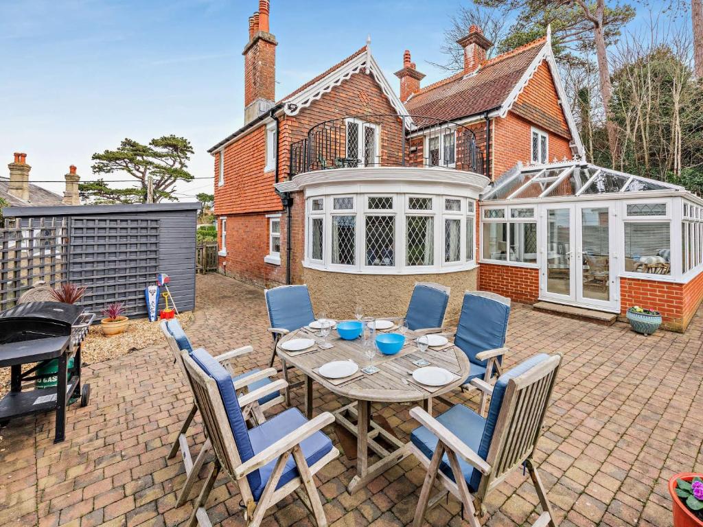 a patio with a table and chairs in front of a house at 4 Bed in Totland Bay IC032 in Totland