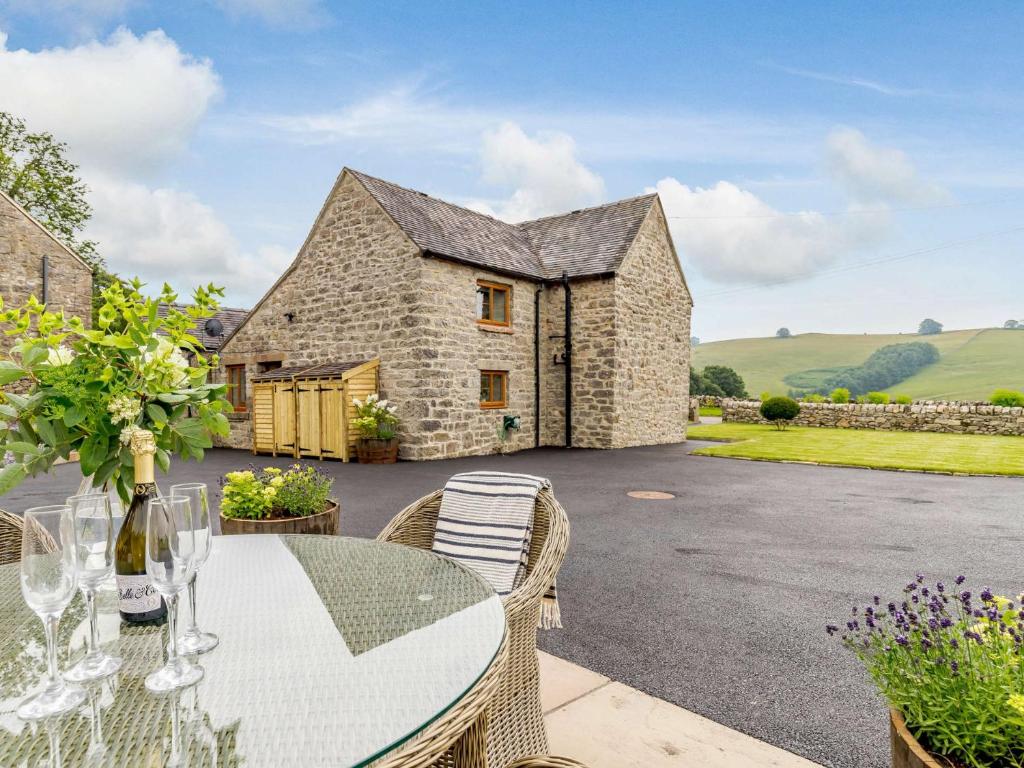 a stone house with a table and chairs in front of it at 2 Bed in Bradbourne 83850 in Bradbourne