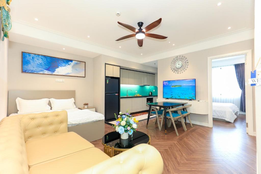 a living room with a couch and a ceiling fan at Altara Apartment Quy Nhon in Quy Nhon