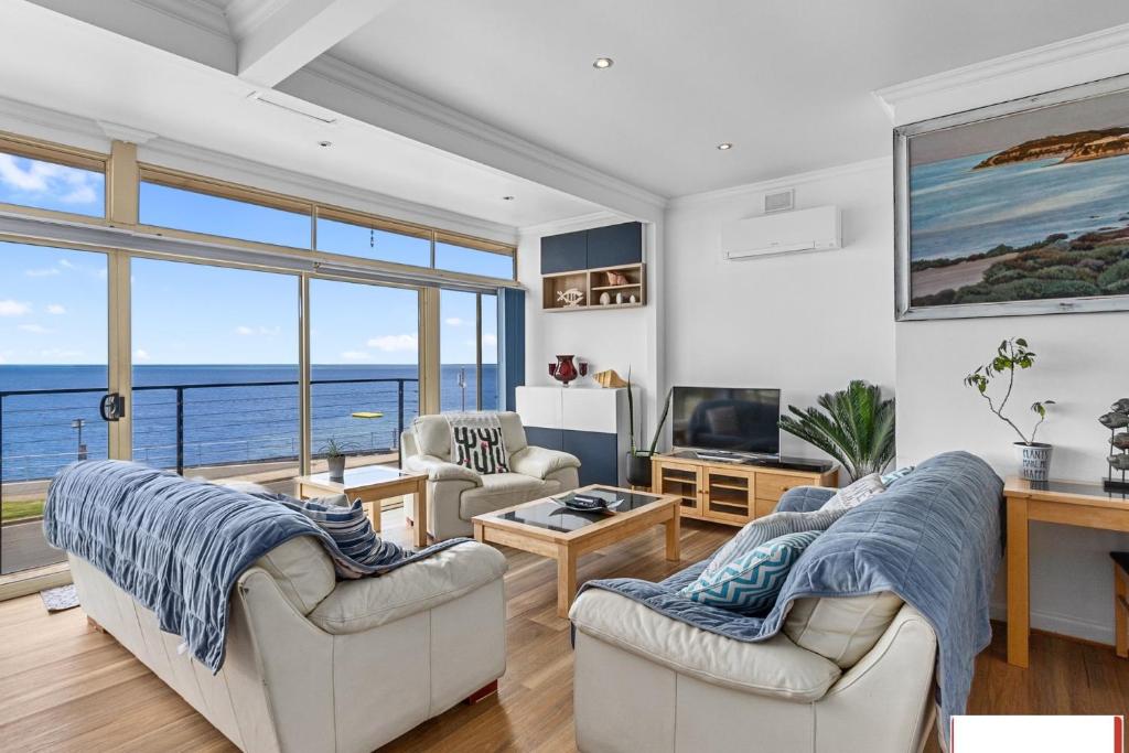 a living room with a view of the ocean at crystal blue apartment in Port Vincent