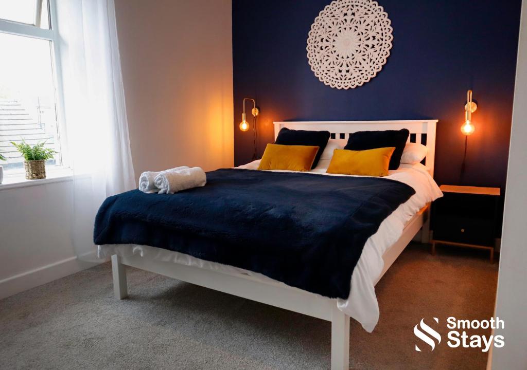 a bedroom with a large bed with yellow pillows at Stylish 2 Bed House In The Heart Of Clitheroe By Smooth Stays Short Lets & Serviced Accommodation With Parking in Clitheroe