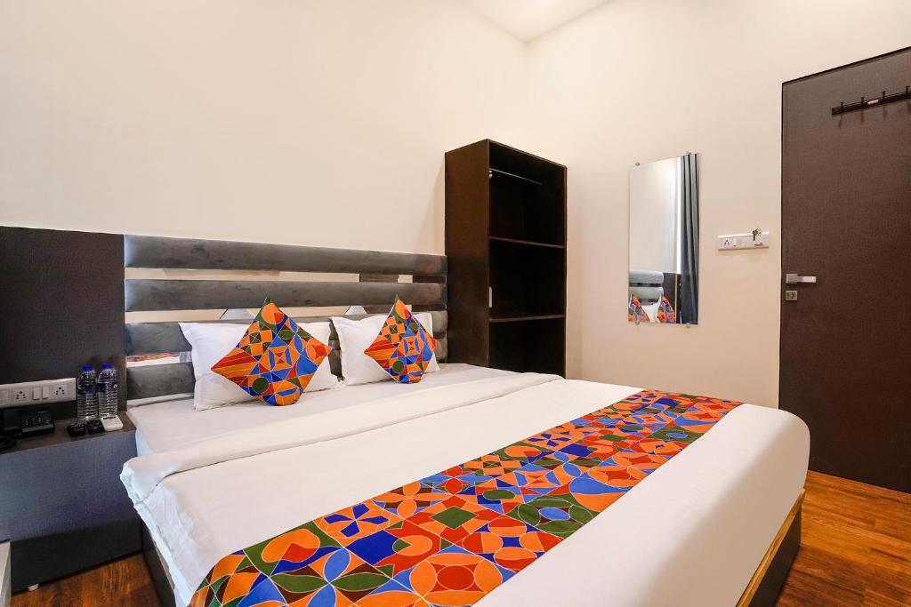 a bedroom with a bed with a colorful blanket at FabHotel Freedom International in Mumbai