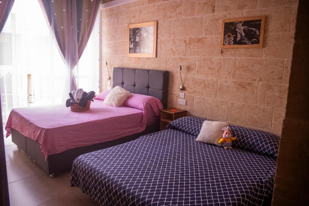Postel nebo postele na pokoji v ubytování Ta Naqċil