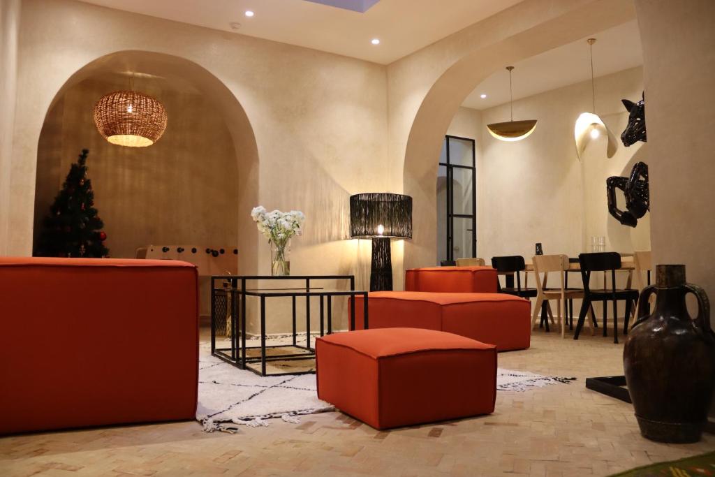 a lobby with red furniture and a christmas tree at Riad Zhor Tanger - Médina in Tangier