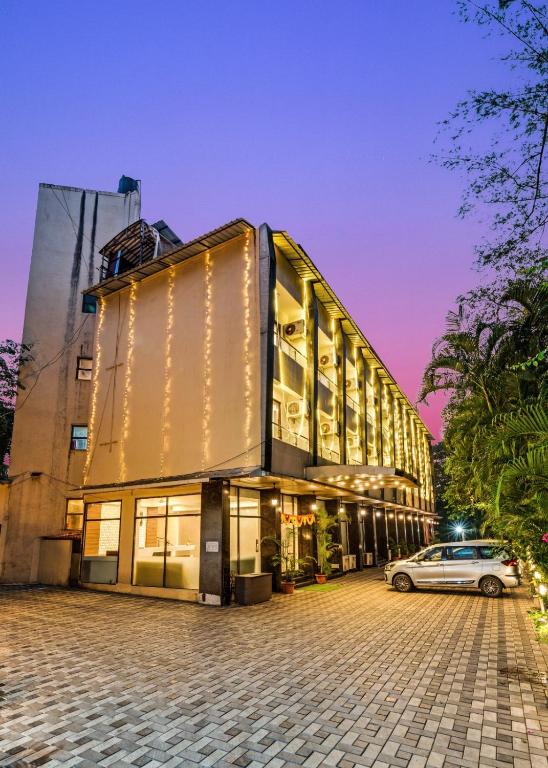 a building with a car parked in front of it at Retreat Heritage in Lonavala