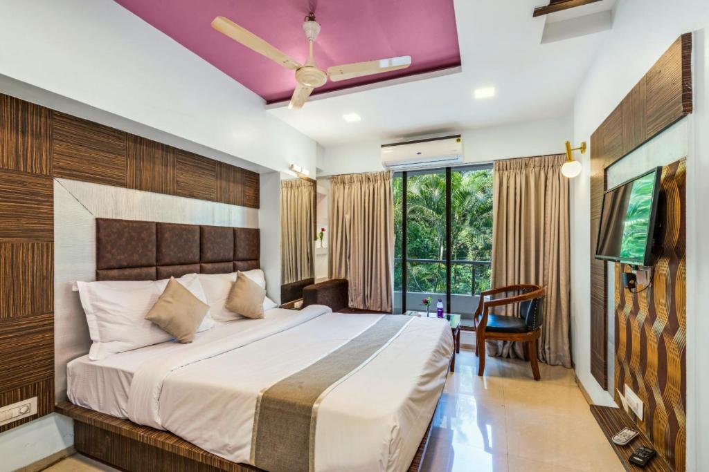 a bedroom with a large bed with a ceiling at Retreat Heritage in Lonavala