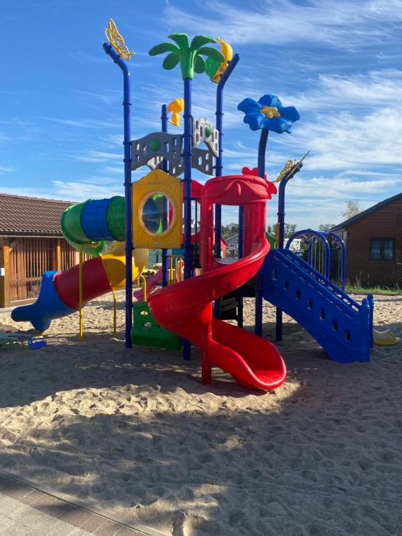 a playground with a slide in the sand at Morska Bryza in Sarbinowo