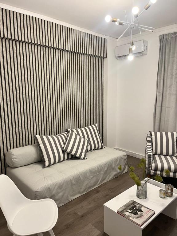 a living room with a couch and a table at Metropolitan Complex Apartment Faliro in Piraeus