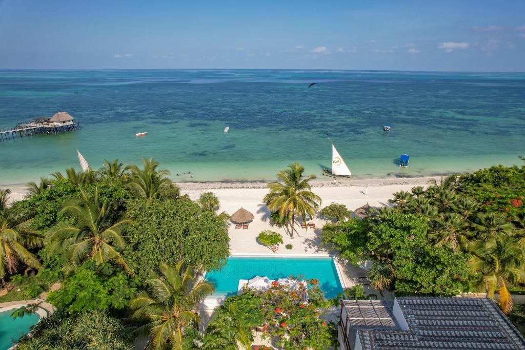 an aerial view of a beach with a boat in the water at Alma Boutique Hotel in Jambiani
