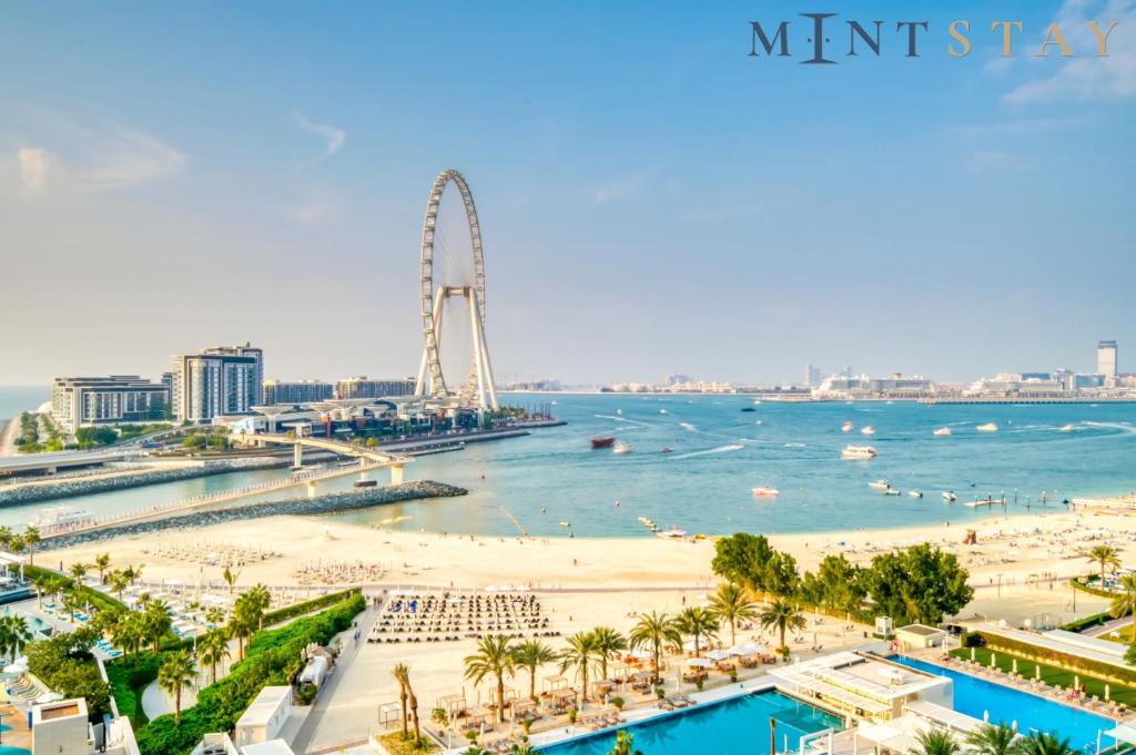a view of the beach and the ferris wheel at Address JBR Sea View, Jumeirah Beach Residence, Dubai Marina - Mint Stay in Dubai