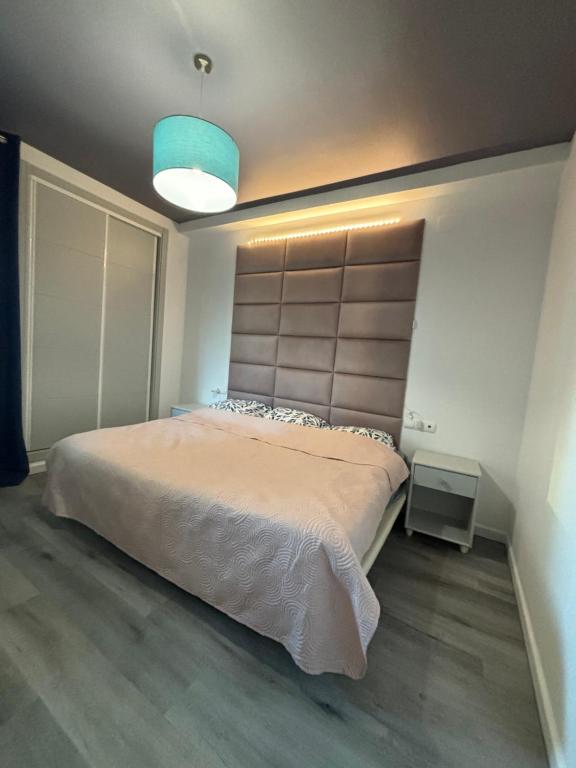 a bedroom with a large bed with a large headboard at Rock&Bike Calpe Sunny Apartment in Calpe