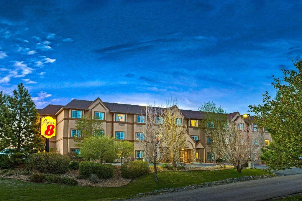 a large building with a sign in front of it at Super 8 by Wyndham Parker/SE Denver Area in Parker