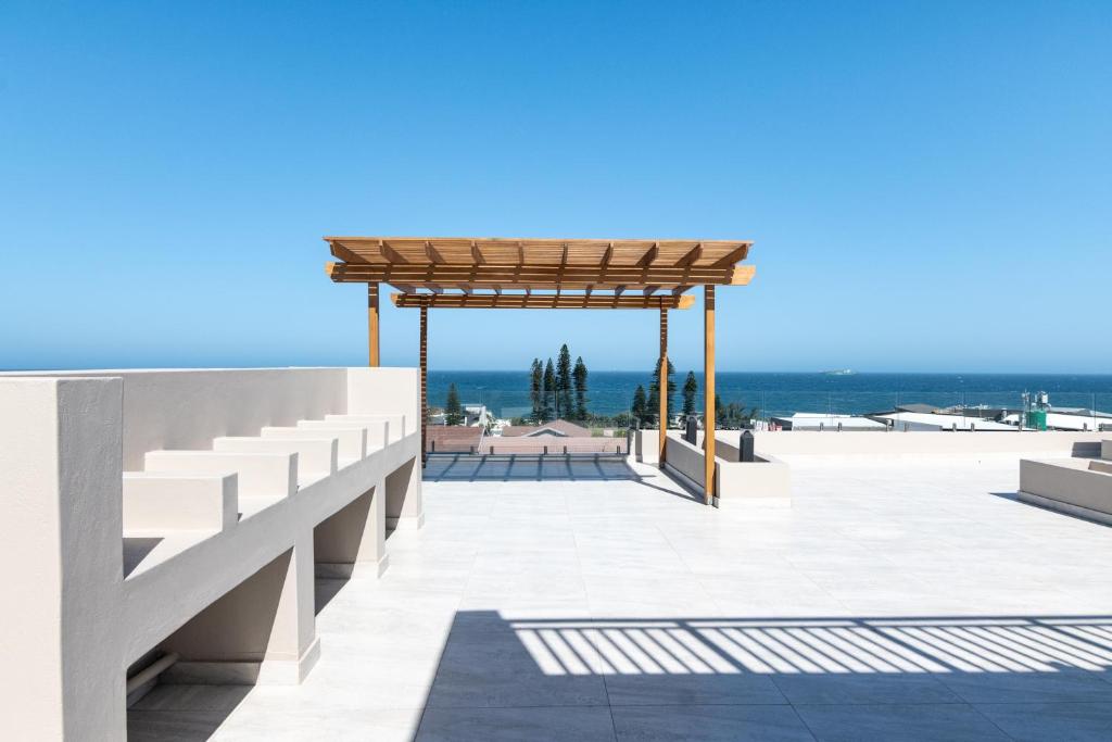 a pavilion on the beach with the ocean in the background at Shanthi Apartment 2 in Ballito