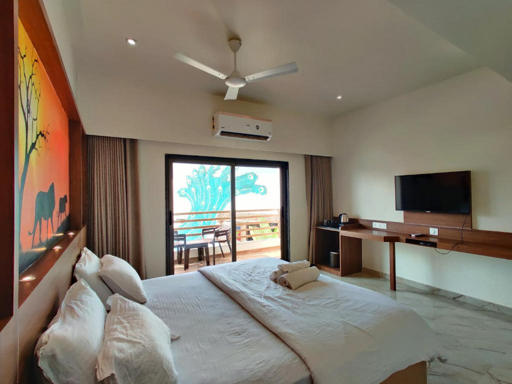 1 dormitorio con 1 cama grande y TV en Wet n wild water park & resort, en Mendarda