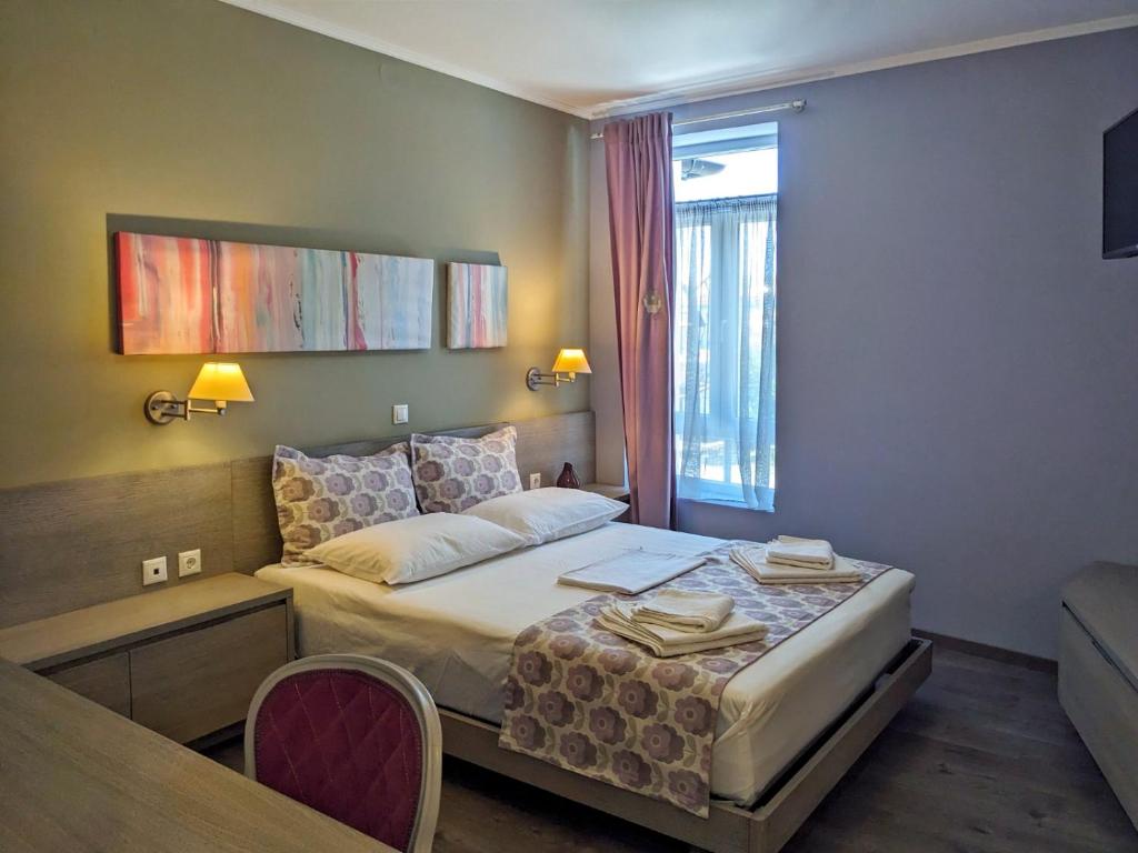 Postel nebo postele na pokoji v ubytování Melina Hotel - Central