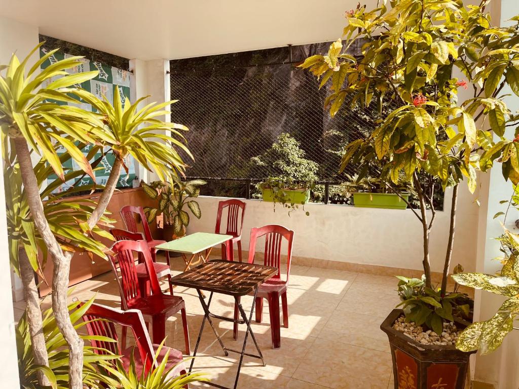 a patio with a table and chairs and plants at Galaxy Home - Hotel Sky view in Cat Ba