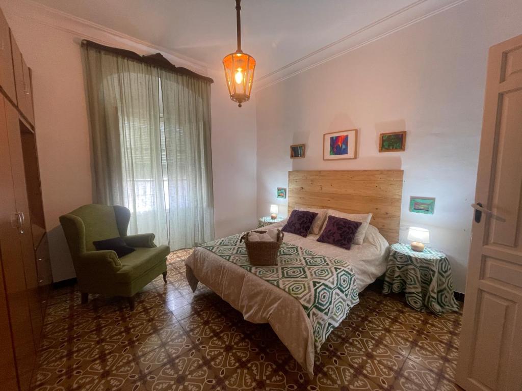 um quarto com uma cama e uma cadeira verde em Casa Muriana em Alanís