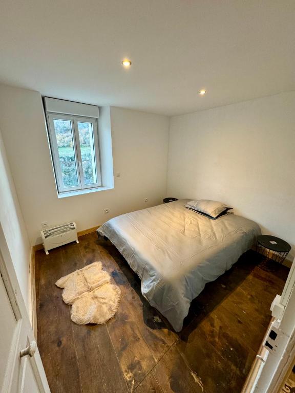 une chambre avec un grand lit et une fenêtre dans l'établissement Charmant appartement, à Serdinya