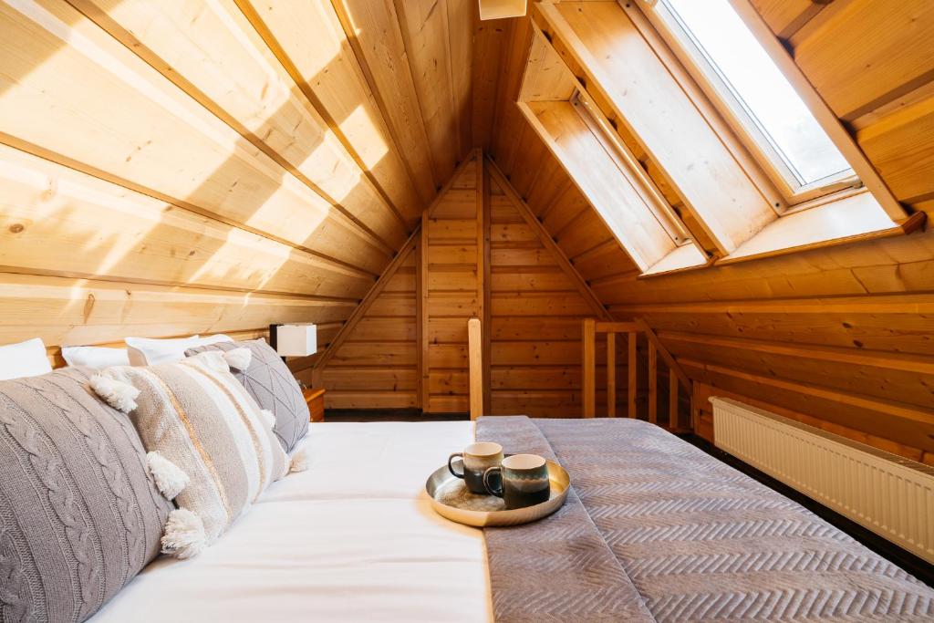 a bed in a room with a skylight at Forest Home Zakopane by LoftAffair in Zakopane