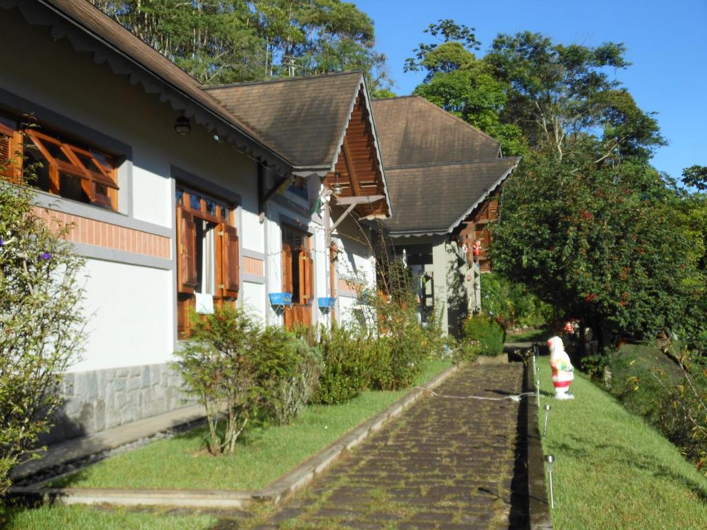 a house with a fire hydrant in front of it at Pousada Pouso do Barão in Domingos Martins