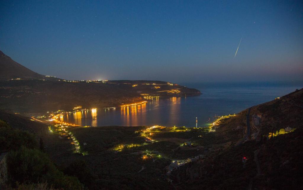 a view of a bay at night from a hill at Olga's House in Neo Itilo